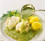 Pouring dill sauce over steamed monkfish