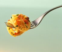 Spaghetti with peperoncino, garlic and parsley on fork