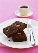 Two pieces of chocolate banana cake and cup of coffee