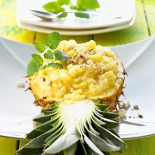 Pineapple rice with nuts in a pineapple half (Thailand)