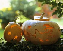 Two pumpkins artistically decorated with star & witch motifs