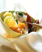 Steamed vegetables with herb & garlic quark on spoon
