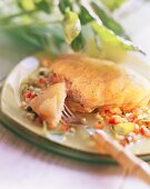 Fish fillets in potato crust on plate with fork