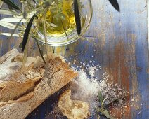 Still life with olive baguette, olive oil & coarse salt