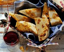 Portuguese bread filled with diced sausage in basket