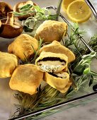 Mushrooms in pastry with herb stuffing on tray; rosemary