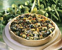 Whole Brussels sprout quiche with pumpkin seeds on large plate