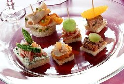 Assorted canapés and croutons on glass plate