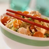 Fried vegetable rice with chicken breast fillet; red chopsticks