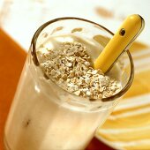 Banana soured milk with oat flakes in glass