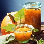Pumpkin and citrus fruit preserve in jar and bowl
