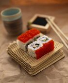 Ura maki (inside out roll) with caviare on bamboo mat