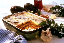 moussaka in baking dish, a piece cut; ingredients