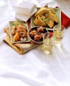 Assorted tapas in bowls on cloth; two sherry glasses