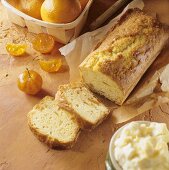 Loaf cake with candied oranges, surrounded by ingredients