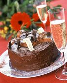 Festive chocolate gateau, champagne and bouquet