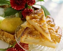 A few pieces of tipsy pear tart on glass plate