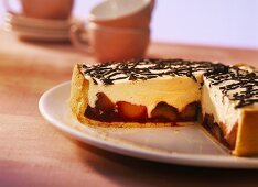 Plum tart with advocaat cream and chocolate strips
