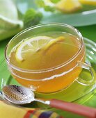 Tea punch with slices of lemon in glass cup