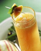 Orange and papaya drink with lemon balm