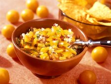 Yellow tomato salsa with onions; tortilla chips