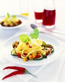 Pan-cooked pasta and vegetable dish with cheese and basil