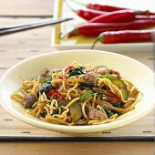Spicy egg noodles with chili peppers and pork