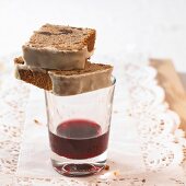 Two pieces of red wine cake on glass of red wine