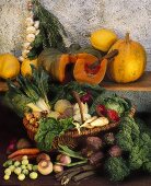 Vegetables in wicker basket, pumpkins on a wooden shelf