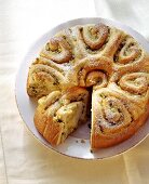 Apple rose cake (coiled bun round) with ginger, piece cut