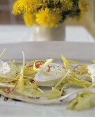 Soft sheep's cheese with dandelion leaves