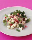 Sheep's cheese salad with pomegranate seeds, onions & herbs