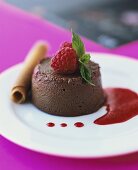 Chocolate ice cream with raspberry sauce and wafer