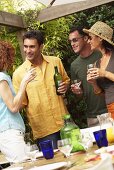 Two couples drinking wine at barbecue