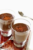 Chocolate cream sprinkled with chili powder, in glasses