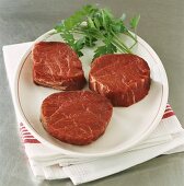 Three beef fillet steaks on plate