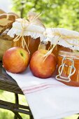 Nectarine jam in jars on table in the open air