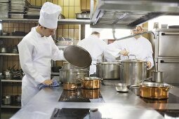 Chef examining the contents of a pan