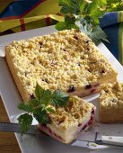 Cheesecake with berries and crumble topping, pieces cut