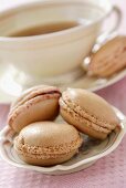 Macaroons filled with rose jam, with tea