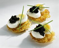Potato rosti topped with quails' eggs, caviar & sour cream