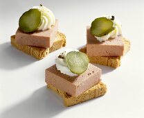 Mini-toasts topped with liver pâté and gherkins