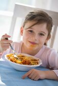 Girl eating spaghetti bolognese