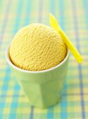 A scoop of mango ice cream in a beaker