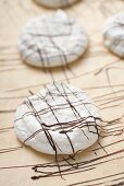 Decorating coconut macaroons with couverture chocolate