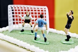 Football pitch cake with players and referee