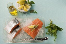 Salmon on crushed ice, olive oil, lemon, bunch of herbs