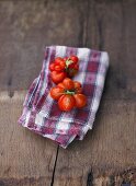 Tomatoes, variety 'Reisetomate, on checked napkin