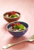 Two bowls of mousse au chocolat with raspberries