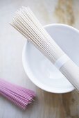 Pink and white somen noodles with a bowl